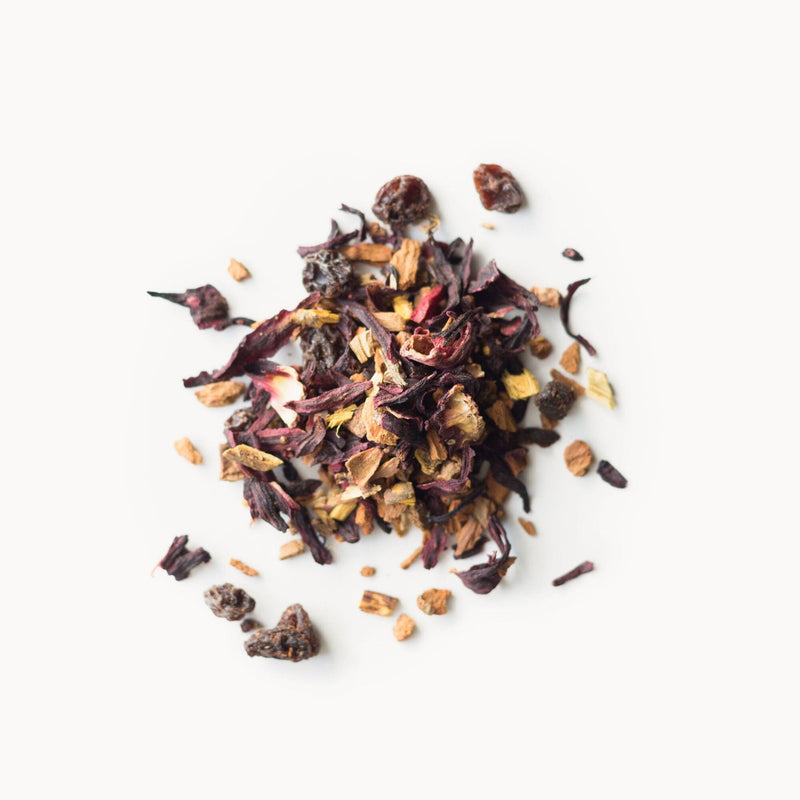 A pile of Cinnamon Plum dried fruit and berries on a white background, produced by Rishi Tea & Botanicals.