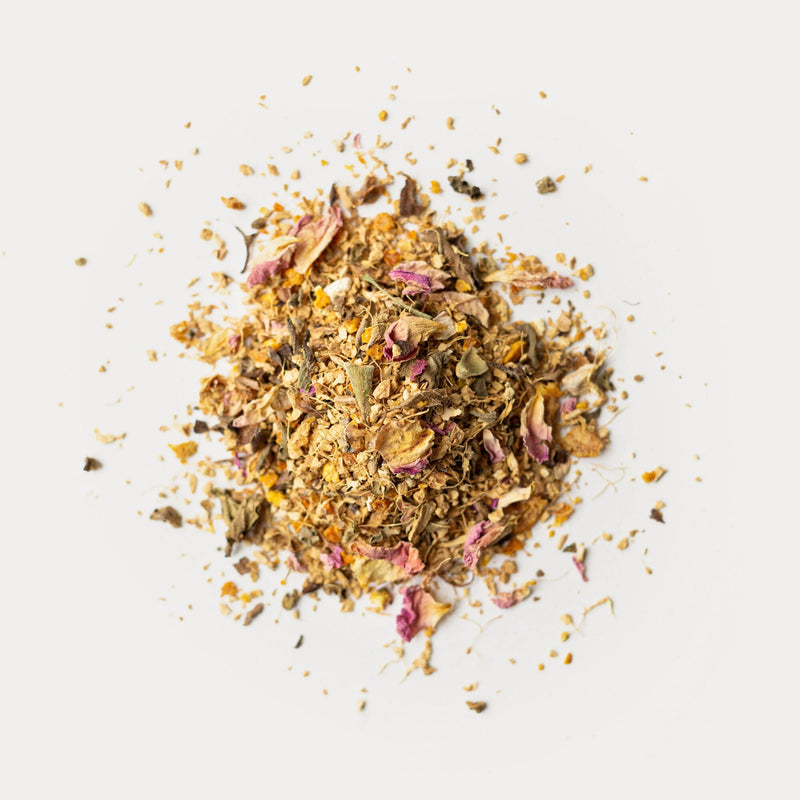 A pile of Ginger Geranium flowers and herbs on a white background. Brand: Rishi Tea & Botanicals.