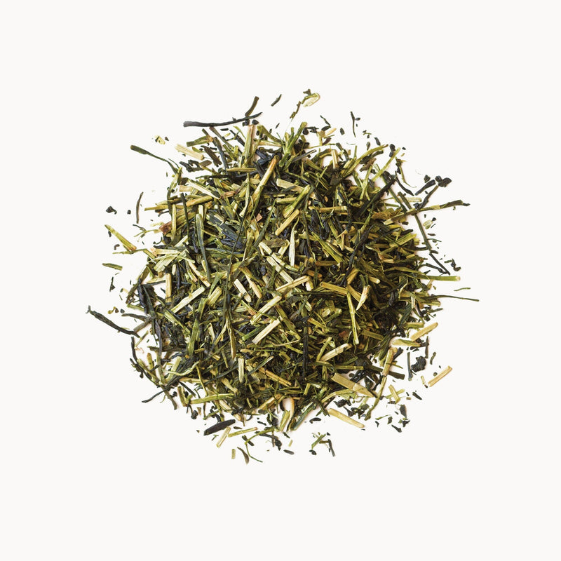 A pile of Kukicha green tea from Rishi Tea & Botanicals on a white background.