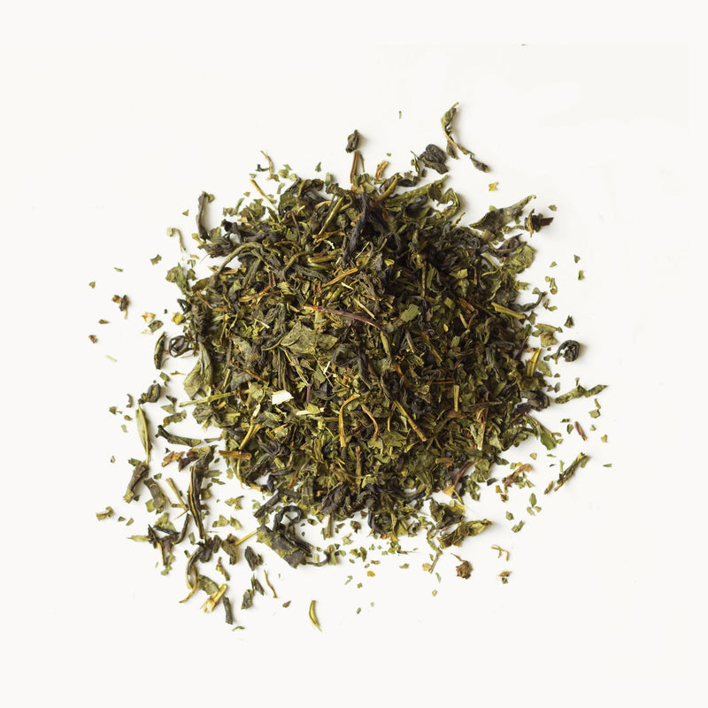 A pile of Moroccan Mint tea from Rishi Tea & Botanicals on a white background.