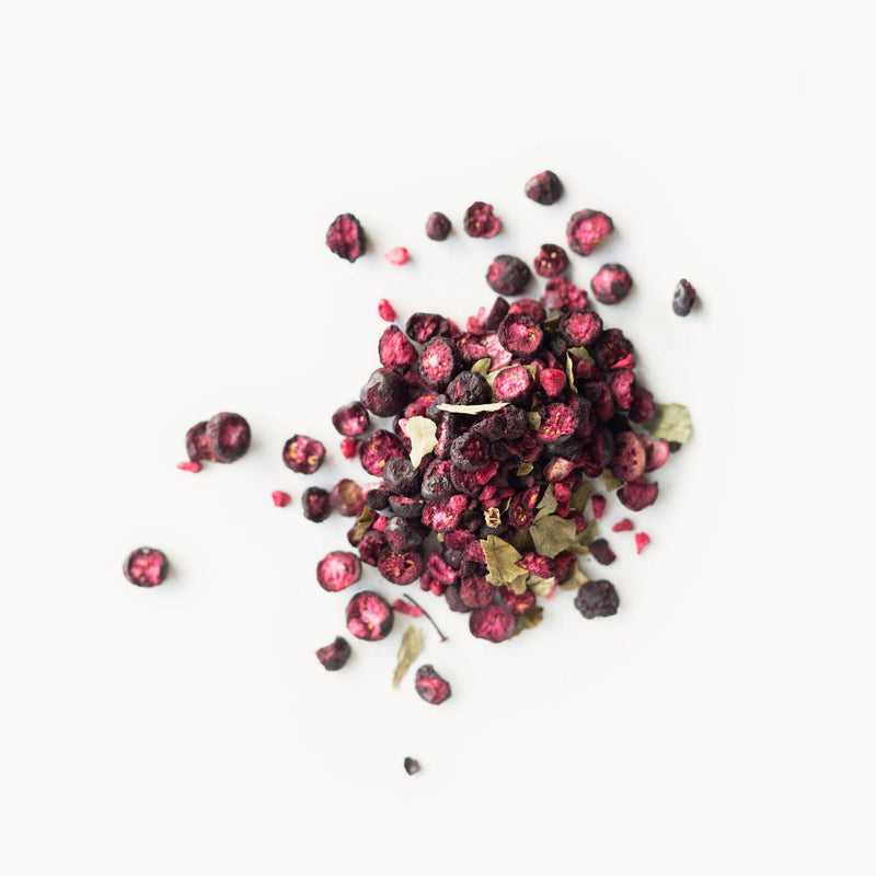 A pile of Patagonia Super Berry-Organic by Rishi Tea & Botanicals on a white background.