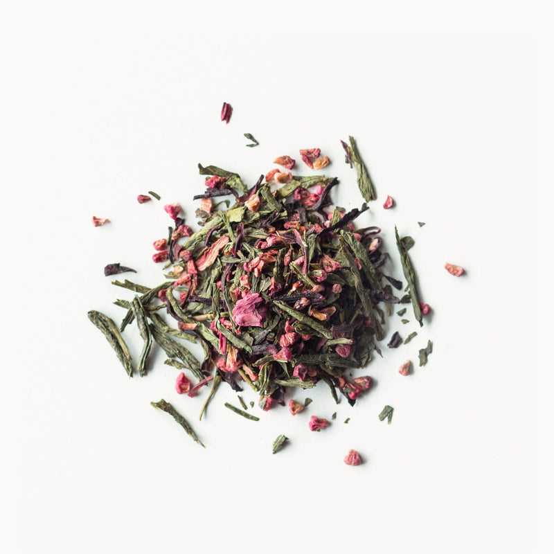 A pile of Raspberry Green Tea - Organic from Rishi Tea & Botanicals on a white background.