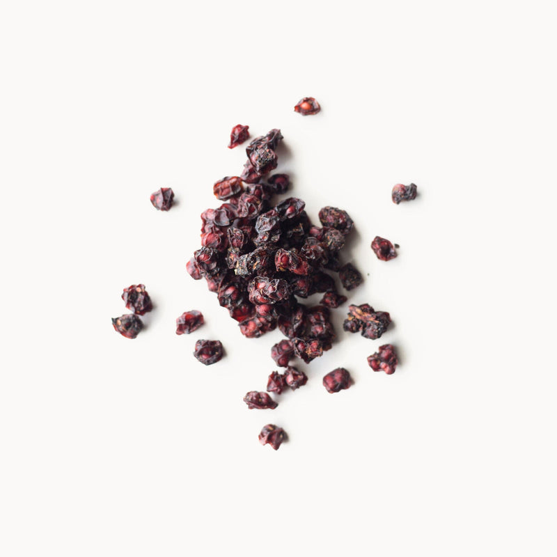 A pile of Schisandra Berries from Rishi Tea & Botanicals on a white background.