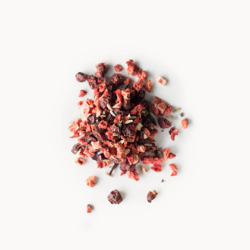 A pile of Schisandra Berry Blush from Rishi Tea & Botanicals on a white background.