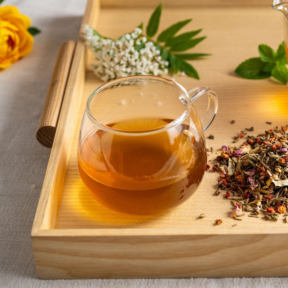 A wooden tray with a cup of Valerian Dream tea and flowers from Rishi Tea & Botanicals.