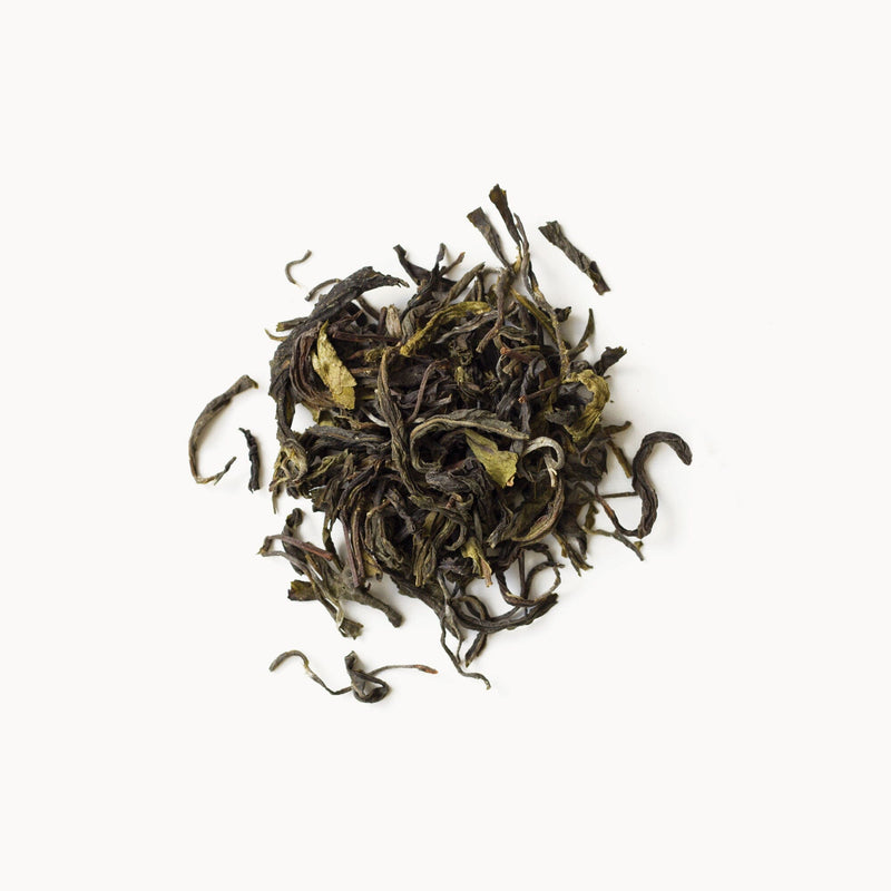 A pile of Wild Thai Green tea from Rishi Tea & Botanicals on a white background.