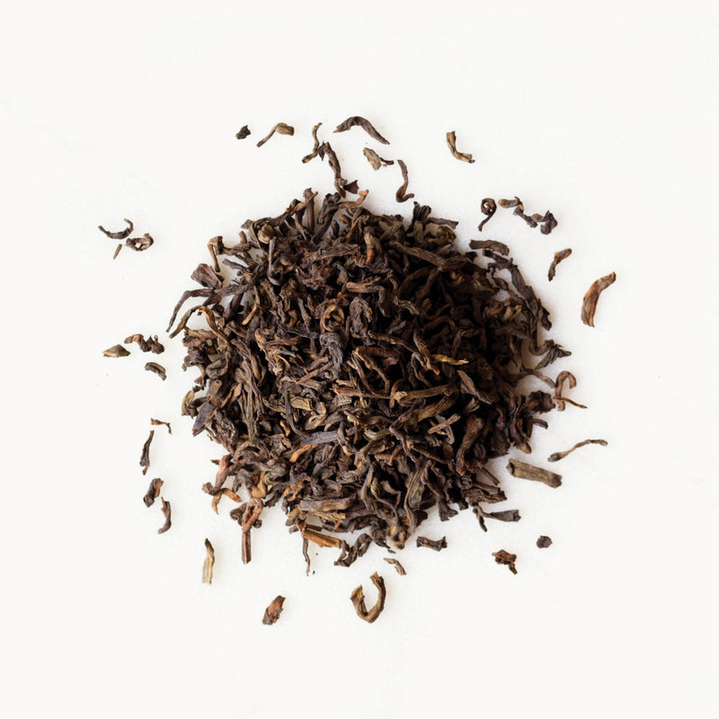 A pile of Pu’er Classic tea from Rishi Tea & Botanicals on a white background.