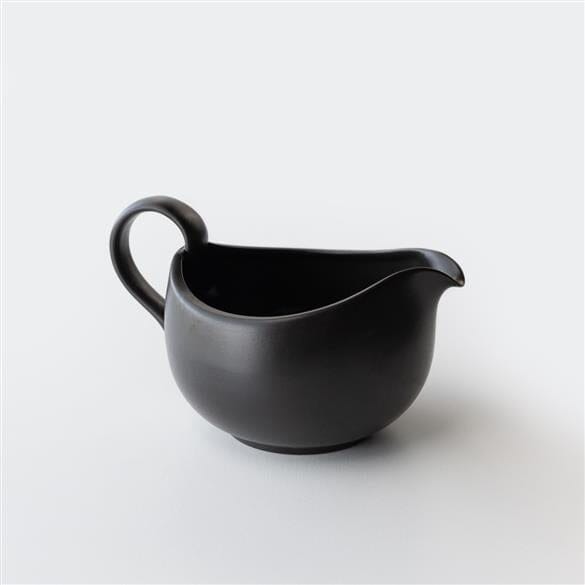 A black Tokoname Yuzamashi Black Cooling Pitcher from Chato Co., Ltd. sitting on a white surface.