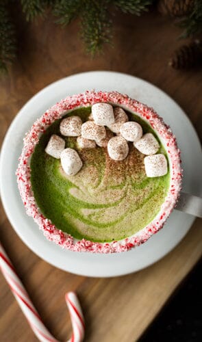 Matcha drink from above with candy canes and marshmallows