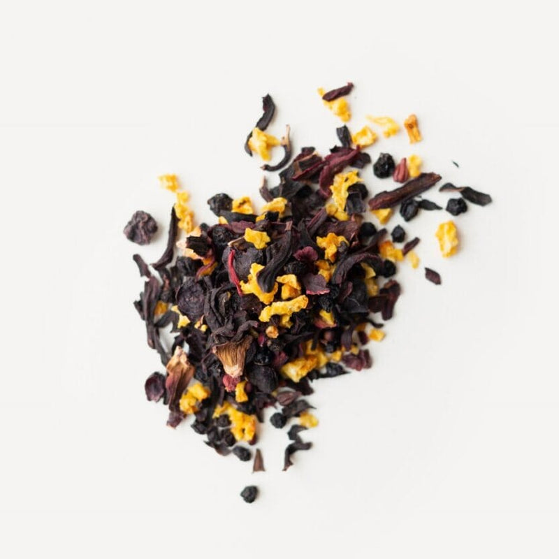 A pile of Rishi Tea & Botanicals Hibiscus Elderberry on a white background.