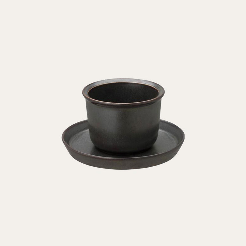 The Kinto Hasami Porcelain Teacup & Saucer by Kinto USA, Inc. sits elegantly against a plain background.