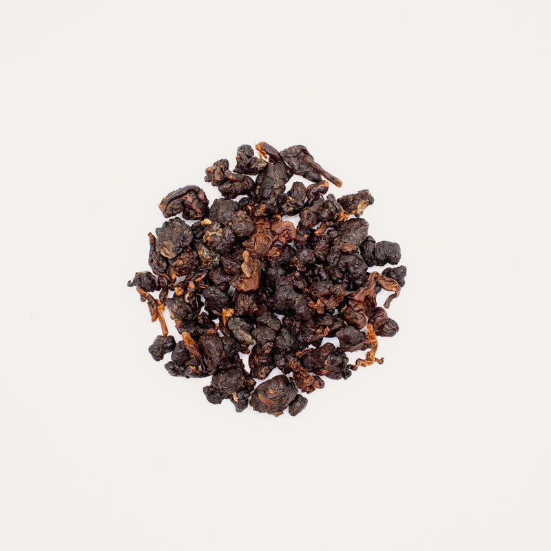 An aged micro-lot of Japanese Whisky Barrel Aged: Chiang Rai black tea from Rishi Tea & Botanicals on a white background, offering a distinct tea taste.