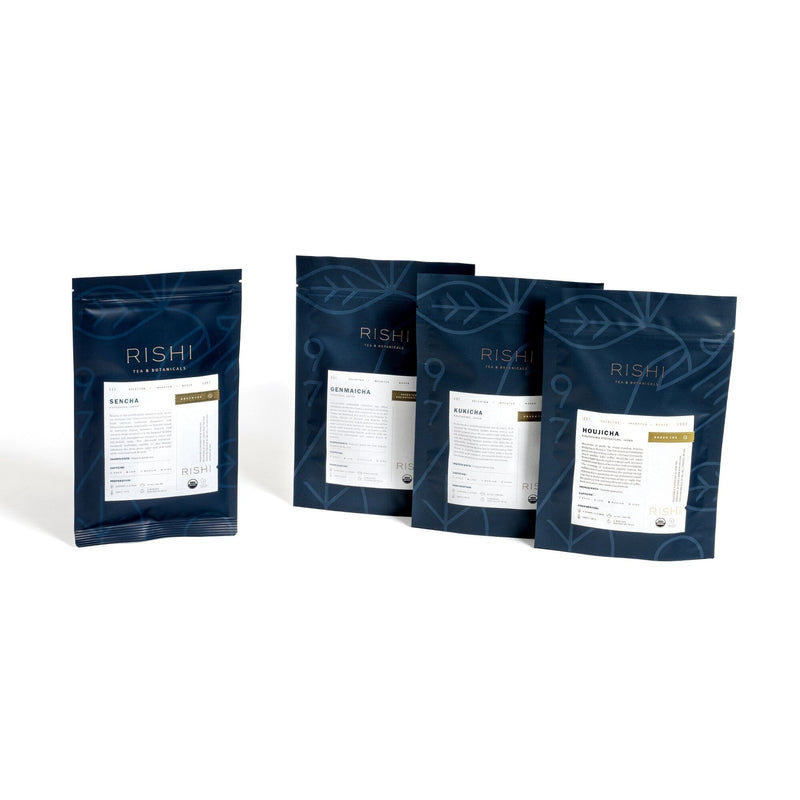 The Japan Flight of Tea Bundle by Rishi Tea & Botanicals is beautifully showcased against a white background, presenting an authentic green tea experience. It includes three packages of Genmaicha, highlighting the richness of Japanese green teas, alongside one package of aromatic Houjicha.