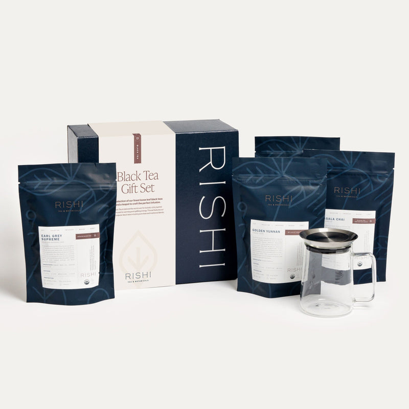 The Black Tea Gift Set, featuring black teas and loose leaf tea, is shown in front of a box.
