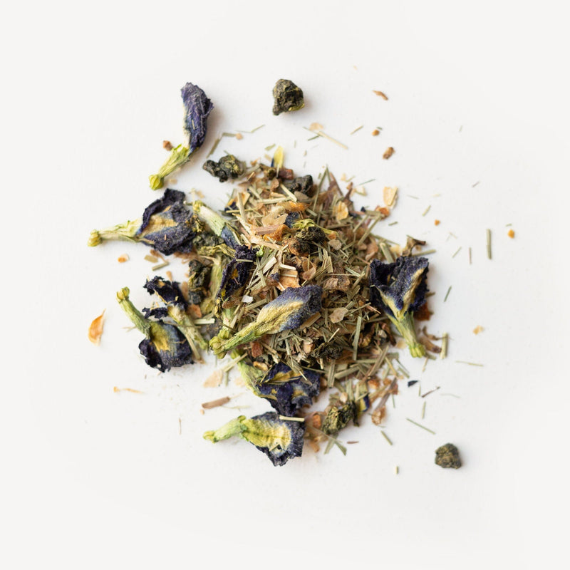 A pile of Rishi Tea & Botanicals Blu-long flowers on a white surface.