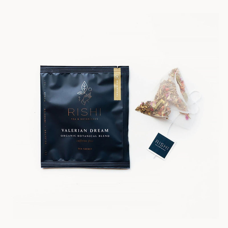 A bag of Valerian Dream tea with a Rishi Tea & Botanicals tea bag next to it.