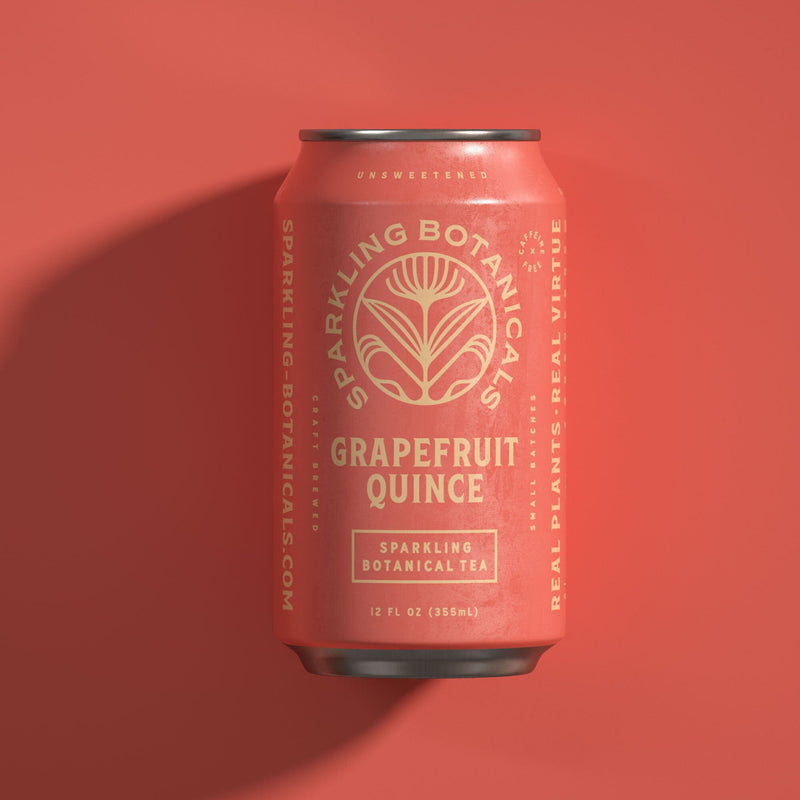 A can of Rishi Tea & Botanicals Grapefruit Quince on a red background.