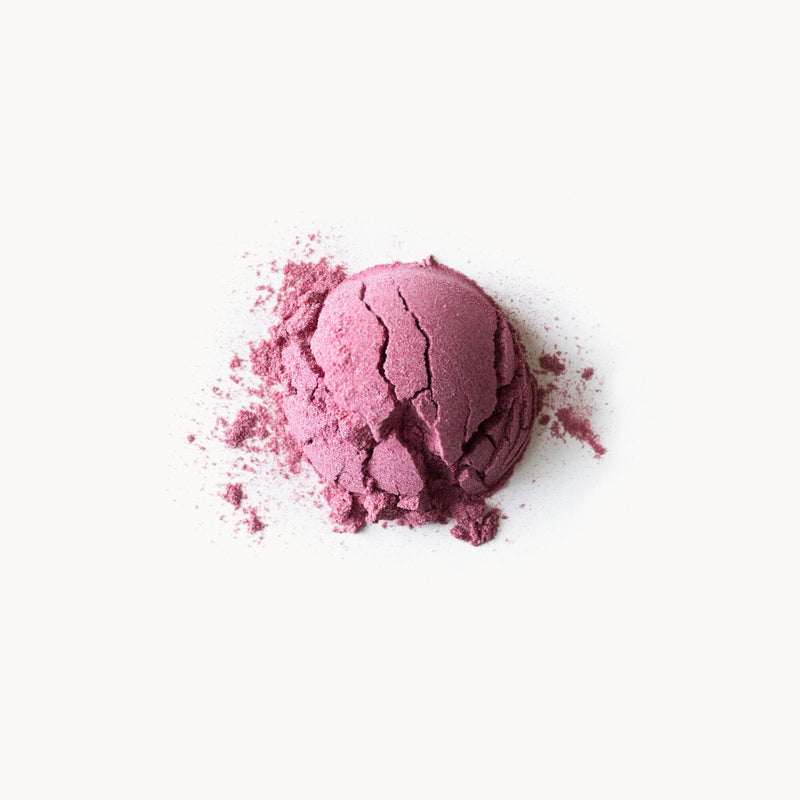 A Hibiscus Mulberry Mangosteen powder on a white background by Rishi Tea & Botanicals.