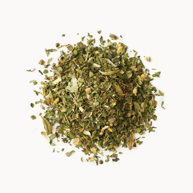 A pile of Mystic Mint dried herbs on a white background by Rishi Tea & Botanicals.