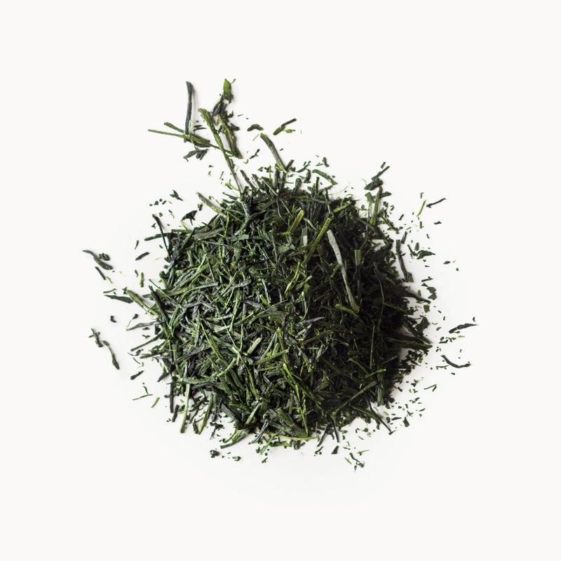 A pile of Nishi Sencha First Flush green tea on a white background. (Brand Name: Rishi Tea & Botanicals)