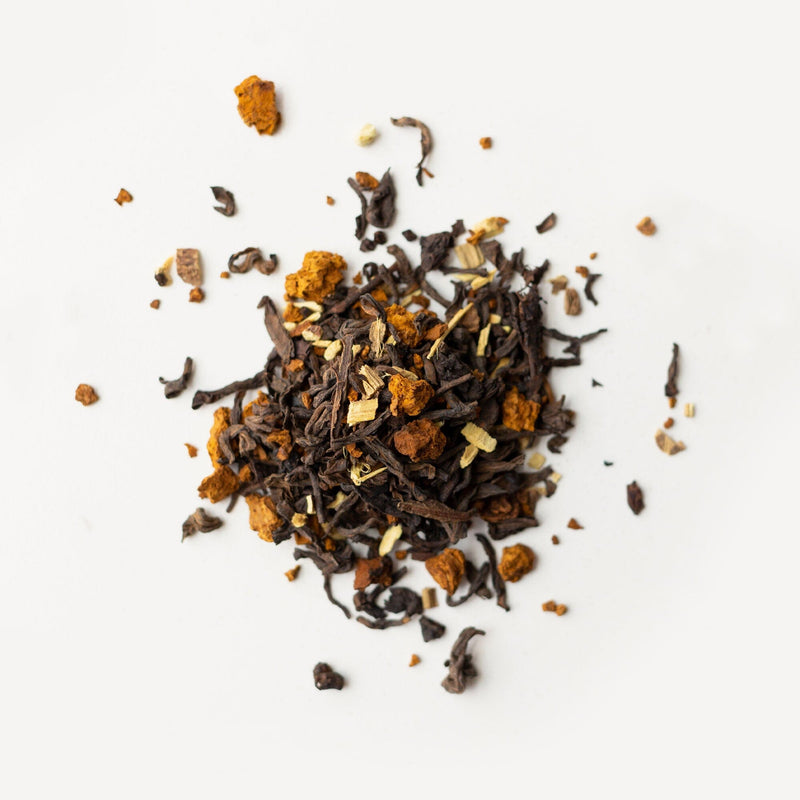 A pile of Pu'er Chaga, Organic tea on a white background from Rishi Tea & Botanicals.