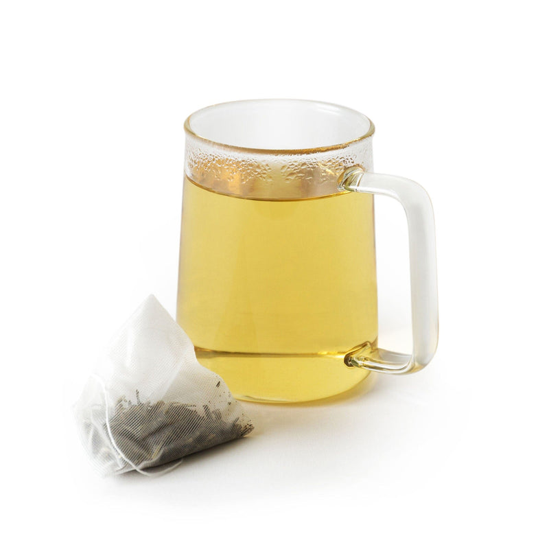 A mug of Moonlight Jasmine Double-Dose tea infused with freshly picked spring harvest tea buds, accompanied by a resealable pouch containing extra-filled double-dose sachets for convenience from Rishi Tea & Botanicals.