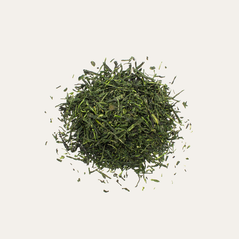 A small pile of Hand-Picked Gyokuro Samidori by Rishi Tea & Botanicals, set against a plain, light background.