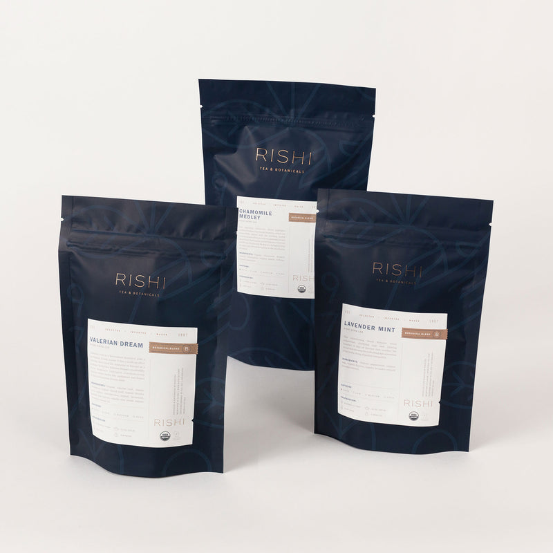 Three bags from the Nighttime Relaxation Flight of Tea Bundle by Rishi Tea & Botanicals stand upright against a plain background. The labels read 