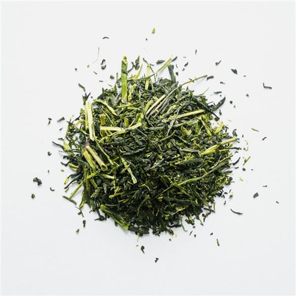 A pile of Okabe Deep Green Kabuse Sencha from Rishi Tea & Botanicals on a white background.