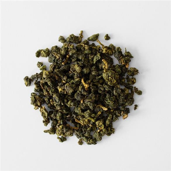 A pile of Li Shan GSC Spring Harvest Steep Slopes green tea on a white background, from Rishi Tea & Botanicals.