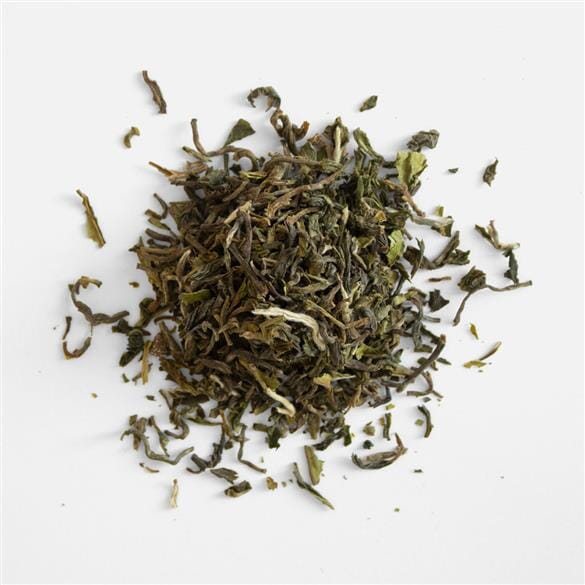 A pile of Darjeeling First Flush Chamong EX2 tea from Rishi Tea & Botanicals on a white background.