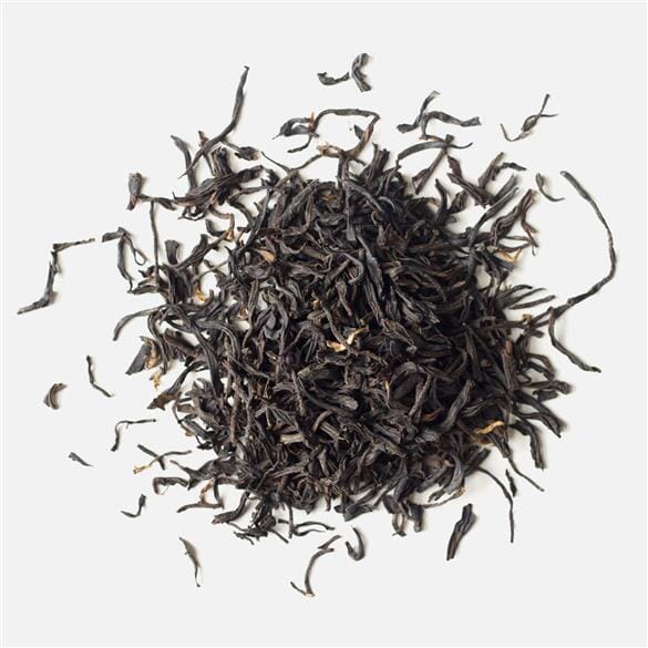 A pile of Yunnan Lily Black tea from Rishi Tea & Botanicals on a white background.