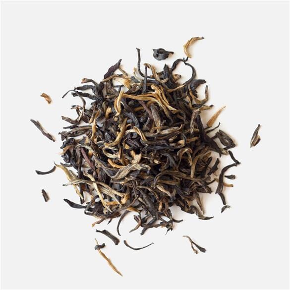 A pile of Xiang Gui Yin Hao Black Tea by Rishi Tea & Botanicals on a white background.