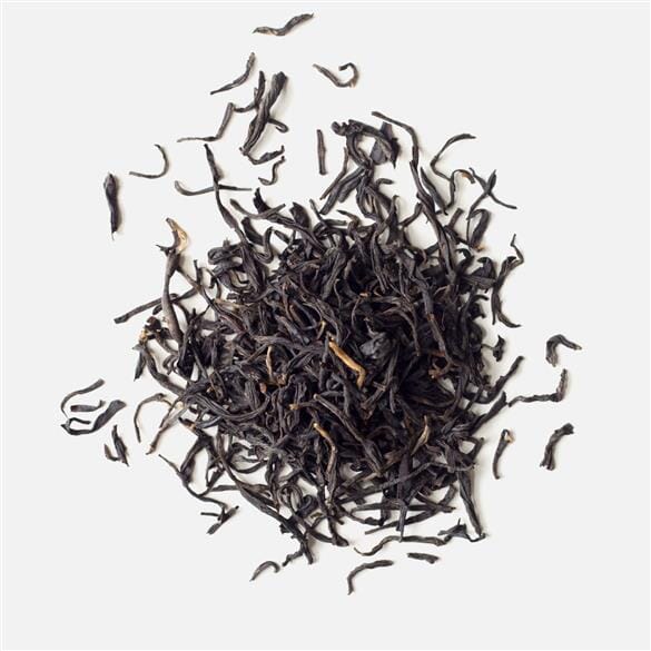 A pile of Yunnan Purple Buds tea by Rishi Tea & Botanicals on a white background.